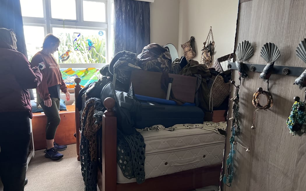 St Kilda resident Rita Stout piled her belongings up onto a bed during flooding, October 2024.