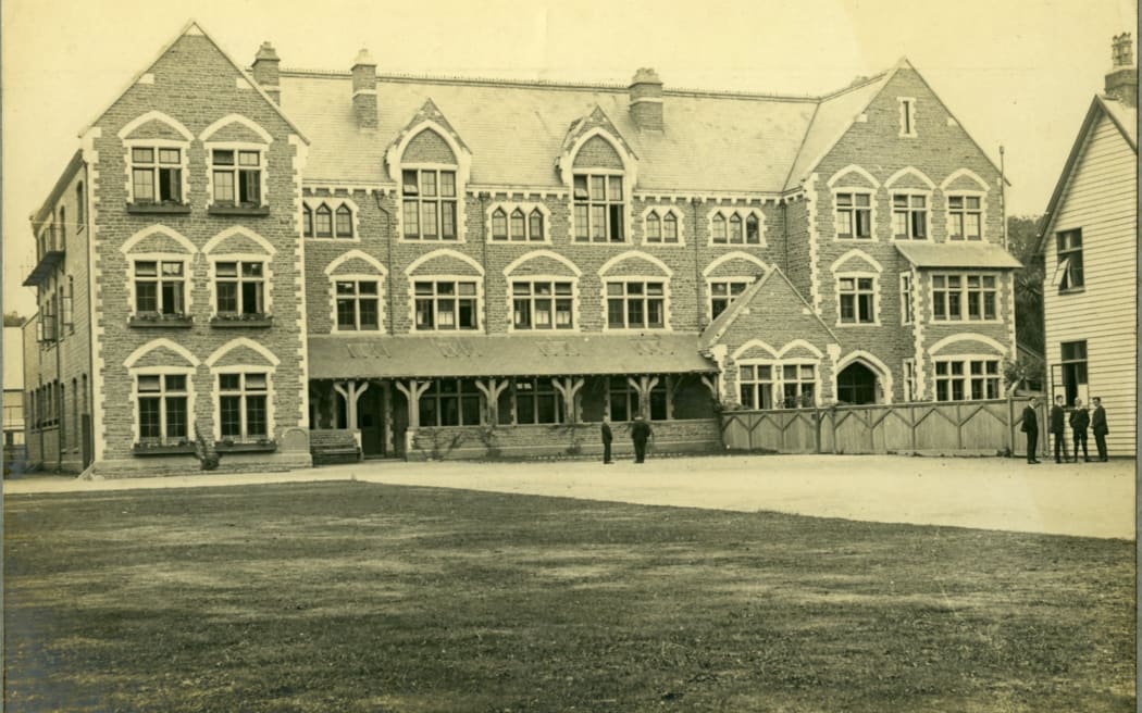An old photo showing the Christ's College campus. A large ornate building. The photo is yellowed with age.