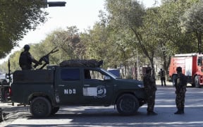 Security personnel stand guard outside Kabul University on November 2, 2020 after gunmen stormed the university.