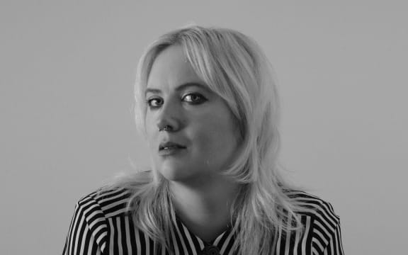 Writer Laura Vincent looks towards the camera in a moody black and white shot