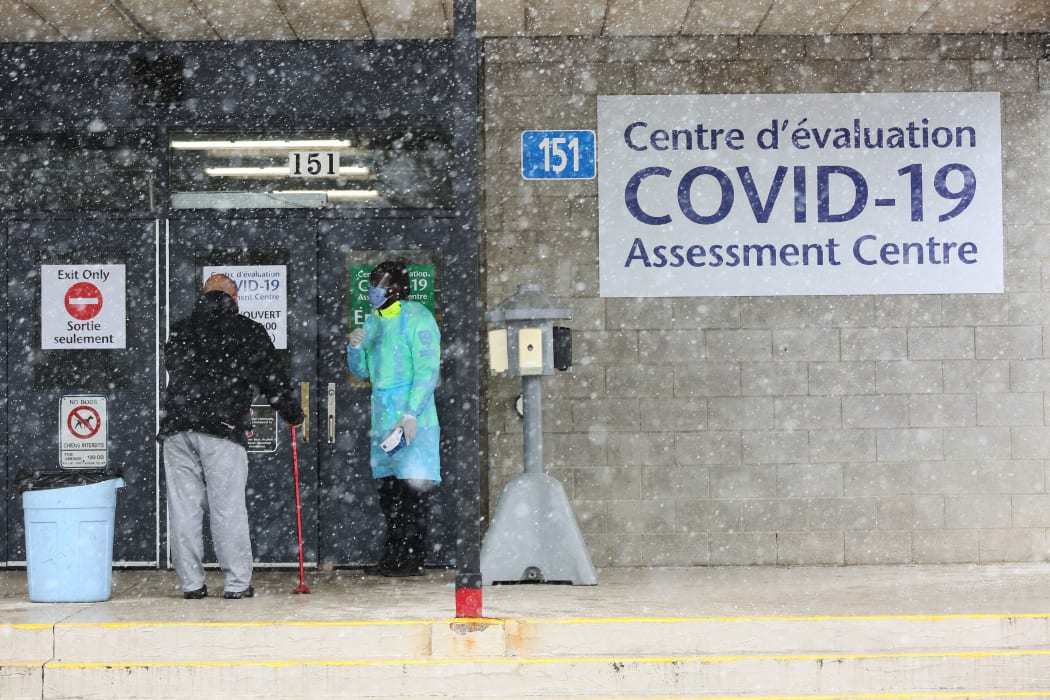 An Ottawa Public Health officer talking to a patient at a Covid-19 testing center in Ottawa, Canada.