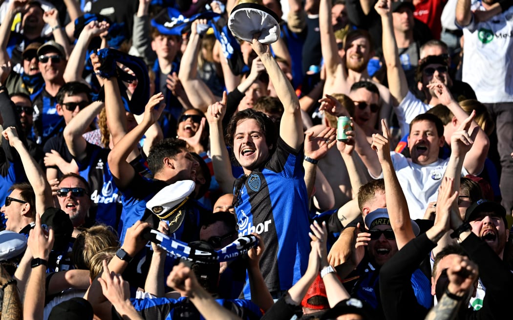 Auckland fans celebrate after scoring a goal during the  A-League