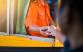 Driver pay for the expressway. Man pays money to a cashier for a toll road toll gate motorway entrance.