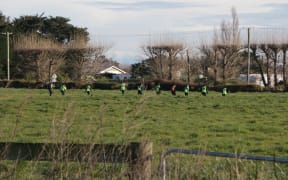 Police and search and rescue combing Greenpark farmland in Canterbury in connection to the homicide case.