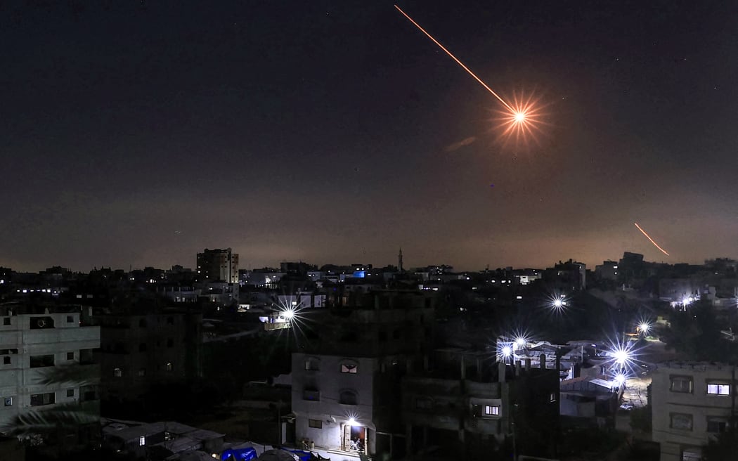 A missile launched from Iran is pictured in the sky from the Bureij camp for Palestinian refugees in the central Gaza Strip on March 1, 2026. The United States and Israel launched strikes against Iran on February 28, killing Iran's supreme leader and top military leaders, prompting authorities to retaliate with strikes on Israel and US bases across the Gulf. (Photo by Eyad Baba / AFP)