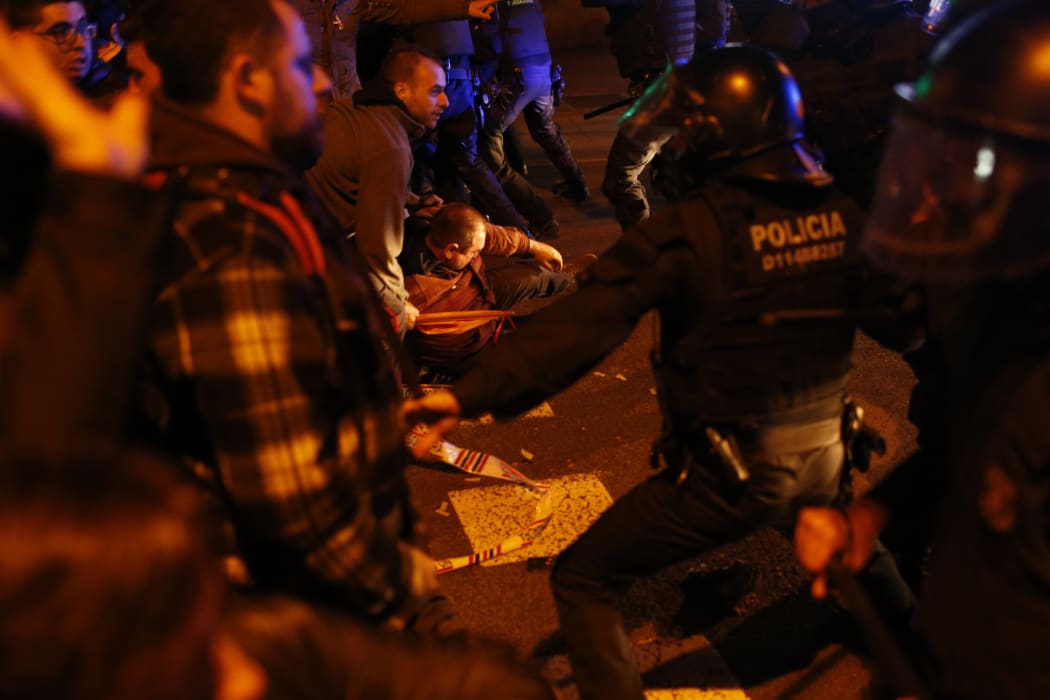 Demonstrators scuffle with riot police officers during a protest called by pro-independence Catalan movements in Barcelona.