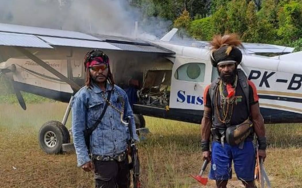 West Papua Liberation Army rebels torch the plane that Phillip Mehrtens was piloting
