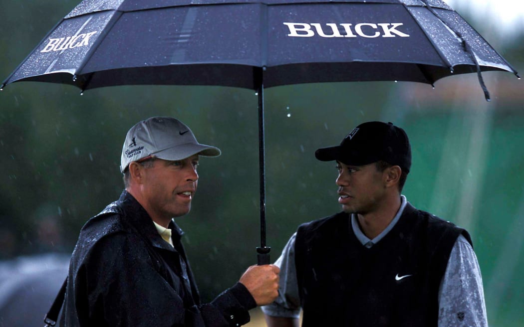 Caddy Steve Williams holds the umbrella for Tiger Woods (USA) in the rain during the New Zealand Golf Open, Paraparaumu, Kapiti Coast, 2002. Photo: PHOTOSPORT *** Local Caption ***
