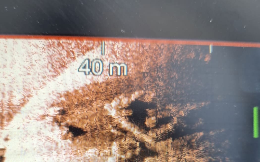 Brendan Wade pointing out at an image from his sonar array.