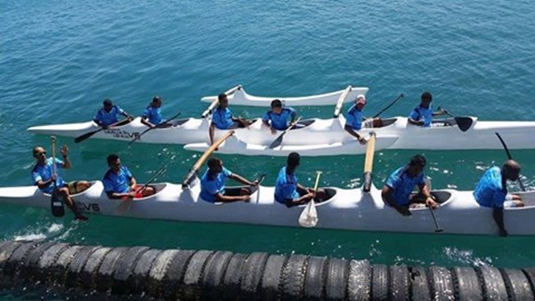 Va'a competitors take to the water.