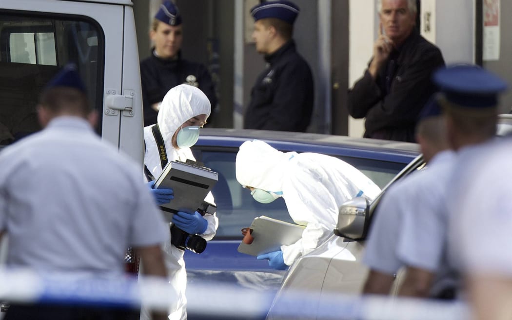 Police forensic experts at the scene of the shooting.