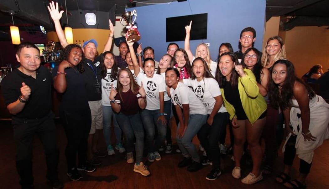 The Masakada players celebrate with the East Asian Cup trophy.