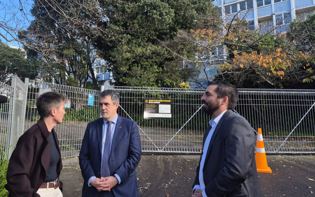 Victoria University acting vice chancellor and provost Bryony James, RMA Reform and Housing Minister Chris Bishop, and Wellington city councillor Ben McNulty outside Wellington's Gordon Wilson Flats on The Terrace.