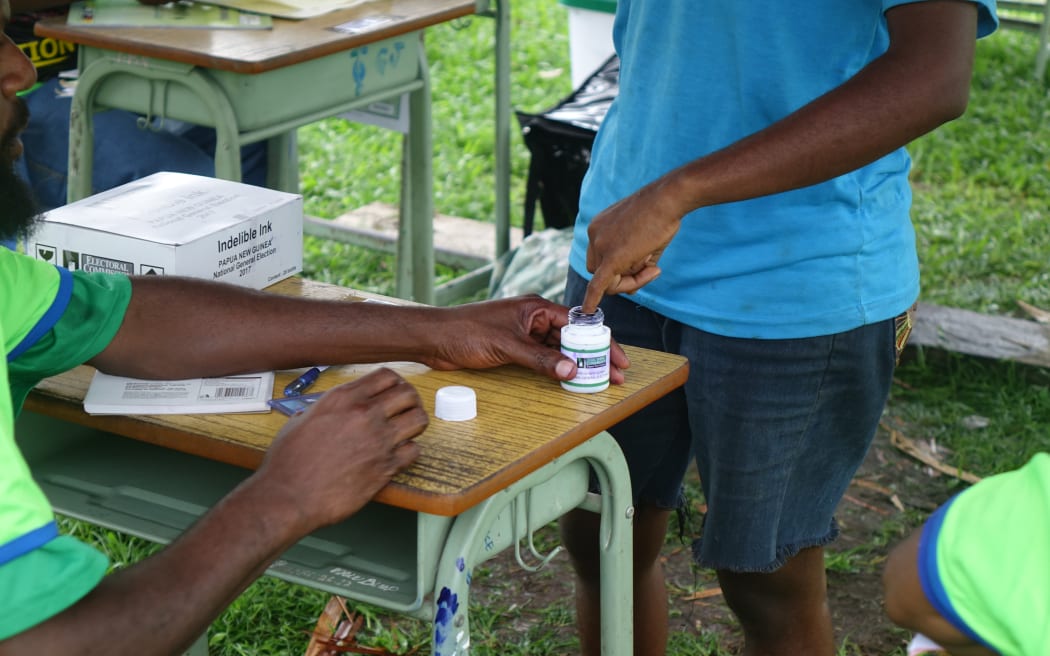 PNG voters must dip a finger into indelible ink before voting, an effort to ensure they don't vote twice.
