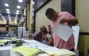 At the Electoral Administration command table Saturday in Majuro working on finalizing all election results, from right: Deputy Election Commissioner Daniel Andrew, election staff Rantly Kattil, Jr. and Bemy Brian, and Chief Electoral Officer Benjamin Kiluwe. Photo: Hilary Hosia.