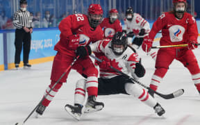 Canadian and Russian Olympic Committee team women's ice hockey players wear masks at the Beijing Winter Olympics 2022.