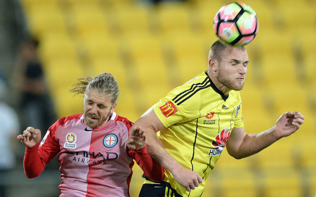 Phoenix striker Hamish Watson wins the battle for possession.