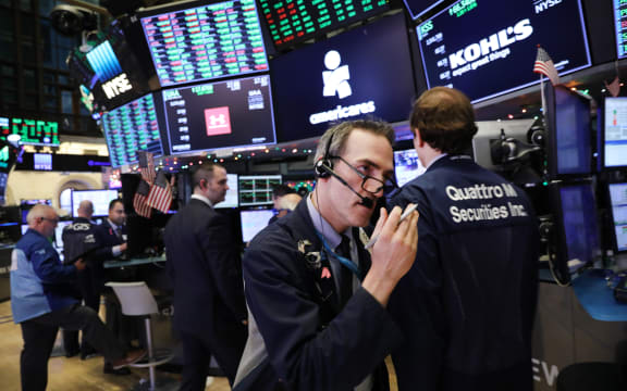 Traders work on the floor of the New York Stock Exchange (NYSE) on the last day of the trading year.