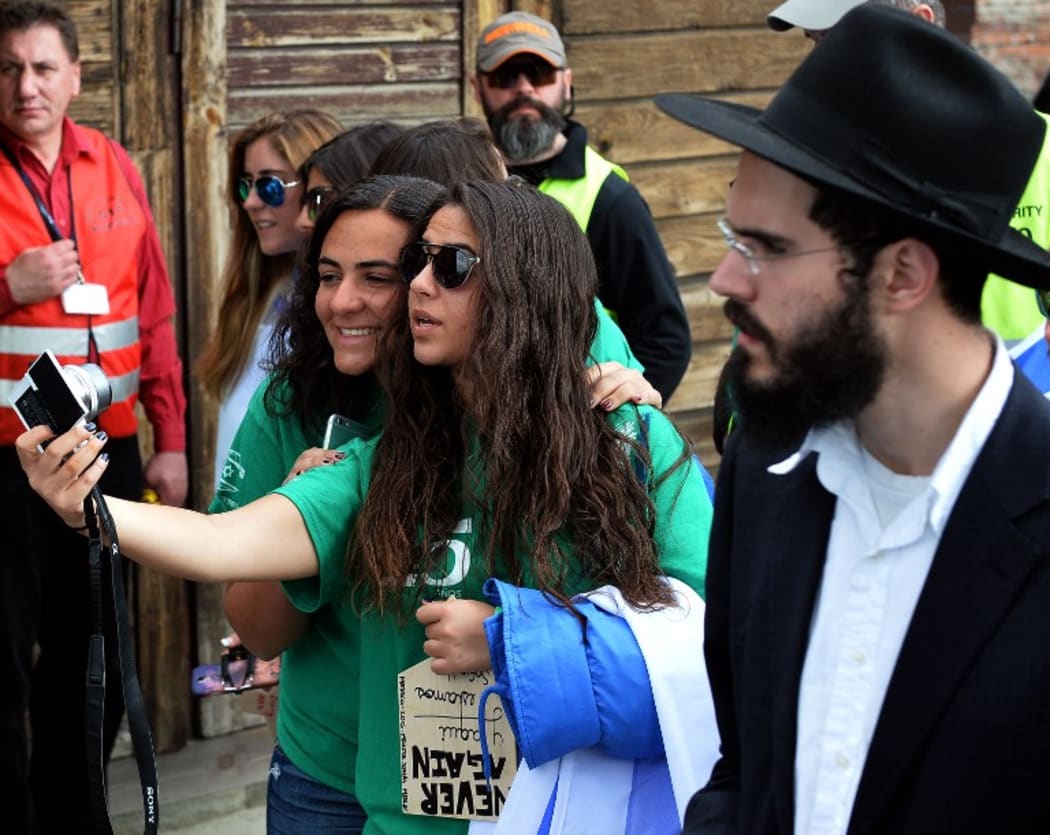 Girls take a selfie at the March of the former Nazi death camp Aushwitz