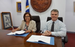 Marshall Islands president Hilda Heine signs an energy project funding grant with the ADB, represented by Michael Trainor, 8 December 2017 in Majuro.