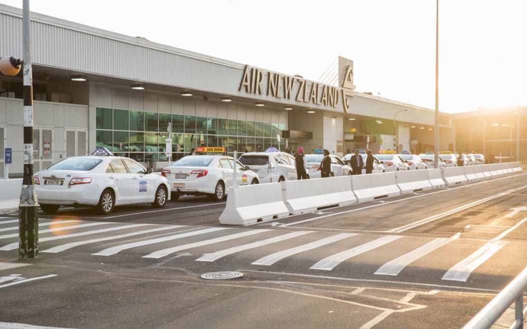 Taxis waiting for fares at Auckland Domestic Airport terminal.