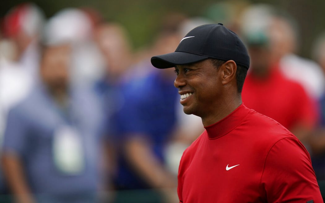 Tiger Woods smiles as he walks off the seventh tee during the final round for the Masters golf tournament, Sunday, April 14, 2019, in Augusta, Ga.