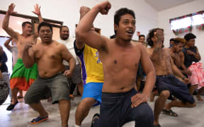 A group of people does a dance.