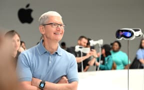 Apple CEO Tim Cook speaks with members of the media next to Apple's new Vision Pro virtual reality headset, during Apple’s Worldwide Developers Conference (WWDC) at the Apple Park campus in Cupertino, California.
