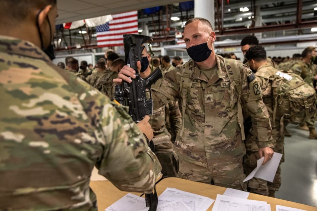 FORT DRUM, NEW YORK - DECEMBER 10: U.S. Army soldiers turn in their weapons after returning home from a 9-month deployment to Afghanistan on December 10, 2020 at Fort Drum, New York.