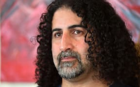 (FILES) Saudi painter Omar bin Laden, the fourth-eldest son of former Al-Qaeda leader Osama Bin Laden, poses during an exhibition of some thirty of his artworks at the "Arielle Brocante", in Le Teilleul, western France, on July 1, 2022. - Saudi painter Omar Bin Laden, has been given an administrative ban from French territory by the authorities, who have obtained his departure, France's Minister of the Interior announced on October 8, 2024. (Photo by Jean-François MONIER / AFP) / RESTRICTED TO EDITORIAL USE - MANDATORY MENTION OF THE ARTIST UPON PUBLICATION - TO ILLUSTRATE THE EVENT AS SPECIFIED IN THE CAPTION