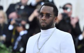 (FILES) Sean Combs 'P. Diddy' arrives for the 2018 Met Gala on May 7, 2018, at the Metropolitan Museum of Art in New York. Homes belonging to Sean "Diddy" Combs were being raided by federal agents, media reported on March 25, 2024, with the US hip hop mogul at the center of sex trafficking and sex assault lawsuits. (Photo by ANGELA WEISS / AFP)