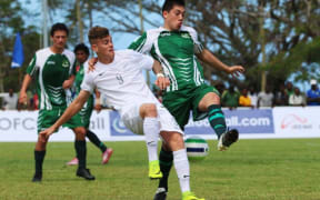 Cook Islands defenderSamuel Maoate-Cox and New Zealand striker Myer Bevan compete for the ball.