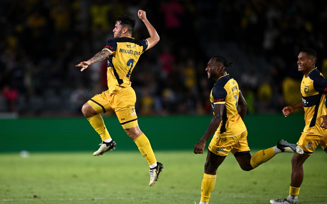 Mikael Doka of the Mariners (left) celebrates with teammates after scoring a goal in stoppage time during the A-League Men Round 23 match between the Central Coast Mariners and Wellington Phoenix at Industree Group Stadium in Gosford.