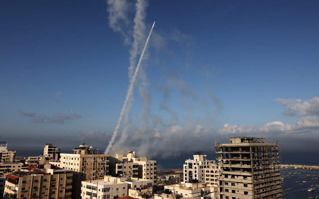 Rockets are fired from Gaza City towards Israel on October 7, 2023. Dozens of rockets were fired from the blockaded Gaza Strip towards Israel on October 7, 2023, an AFP journalist in the Palestinian territory said, as sirens warning of incoming fire blared in Israel.