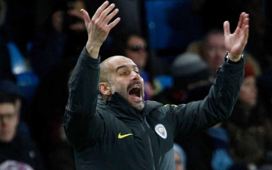 Pep Guardiola gesticulates in the technical area as the clock counts down.