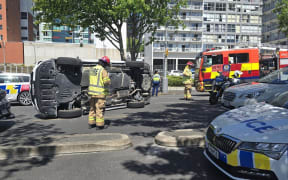 A car is on its side after a crash on Auckland's Nelson Street.