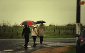 Mourners walking to urupā