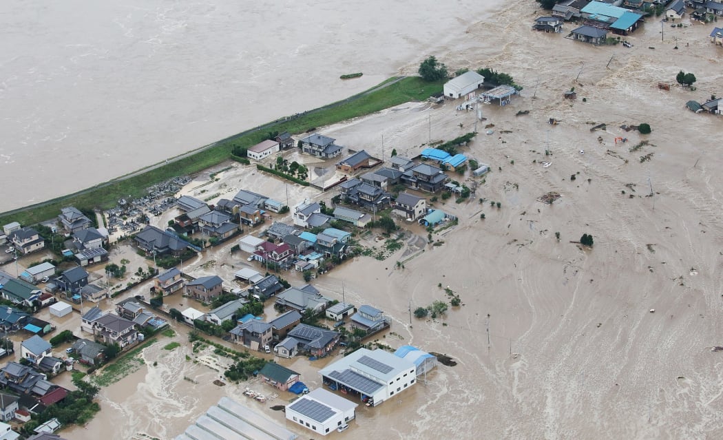 Floodwaters from the burst Kinugawa river flow into a residential area in Joso, Ibaraki.