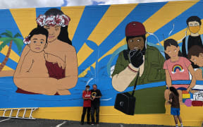 Tigilau Ness and Chris McBride in front of the mural
