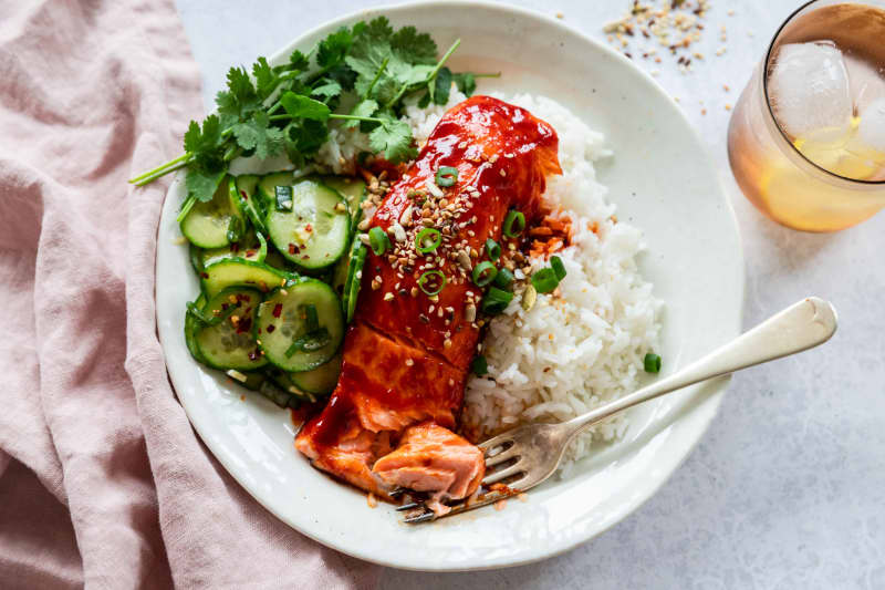 A dish of Roasted Gochujang Salmon with Cucumber Salad, with rice.