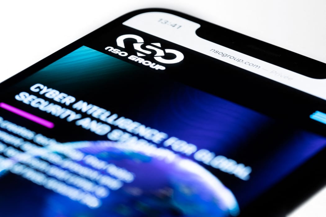 Illustration showing a smartphone with the website of Israel's NSO Group which features 'Pegasus' spyware, on display in Paris on 21 July 2021.