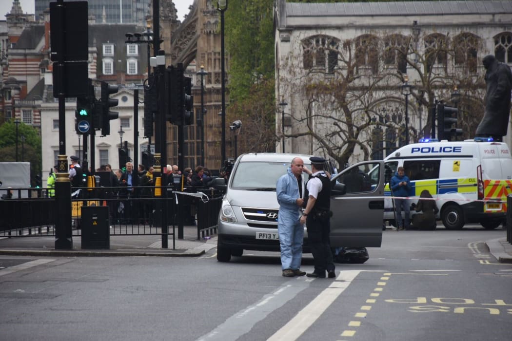 Police patrol near Westminster, where an earlier terror arrest took place. The two events were unrelated, Scotland Yard said.