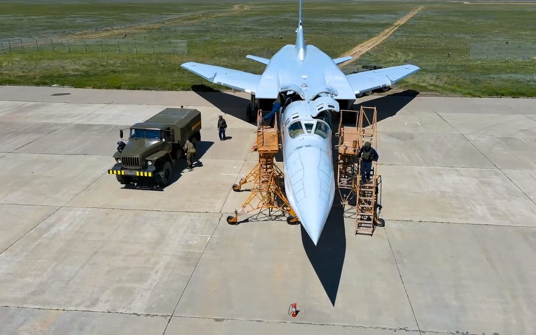 In this photo released by Russian Defense Ministry Press Service on Tuesday, May 21, 2024, Russian air force crew work to prepare a Tu-22M3 bomber for a training mission as part of drills to train the military for using tactical nuclear weapons at an undisclosed location in Russia. Russia's Defense Ministry on Tuesday said it began the first stage of drills involving tactical nuclear weapons. It was the first time Russia has publicly announced drills involving tactical nuclear weapons, although its strategic nuclear forces regularly hold exercises. (Russian Defense Ministry Press Service via AP)