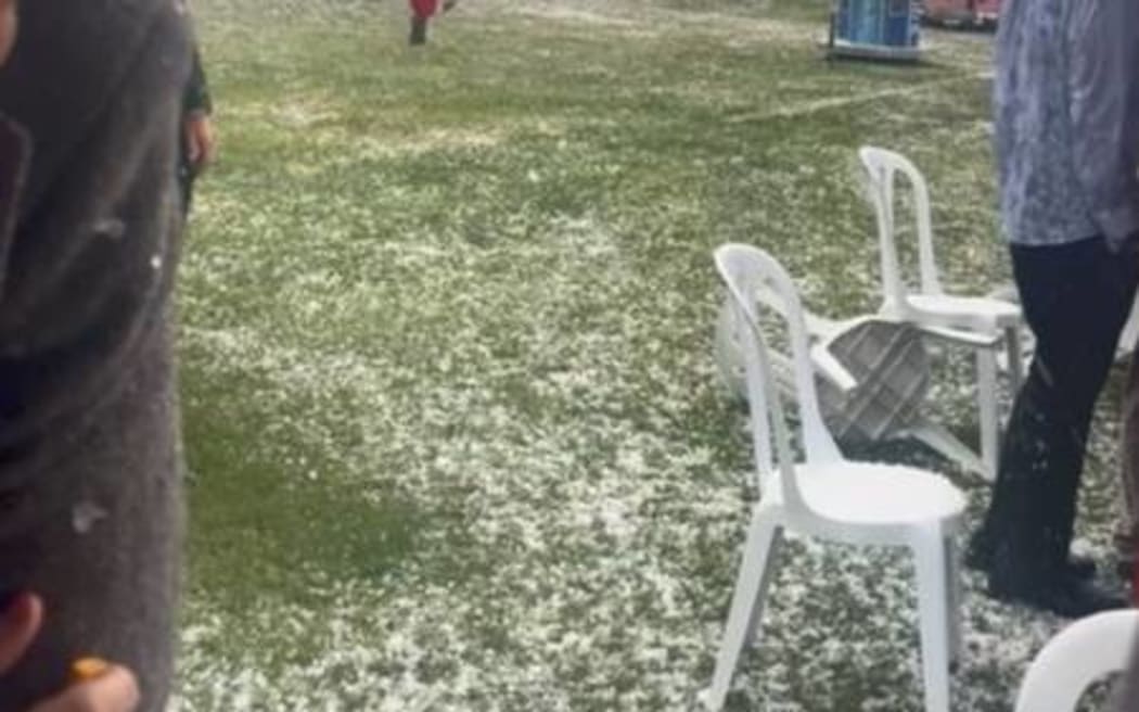 Cup Week patrons scramble for cover during a hailstorm at Riccarton Park.