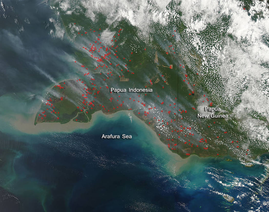 NASA image of smoke and fires in Indonesia's Papua province and neighbouring Papua New Guinea. Actively burning areas are outlined in red. September 2015.