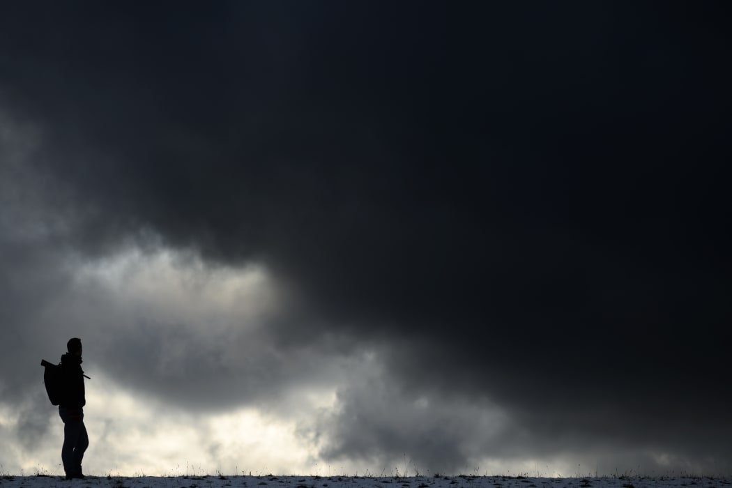 09 November 2019, Baden-Wuerttemberg, Mössingen: A man stands before a dark sky.