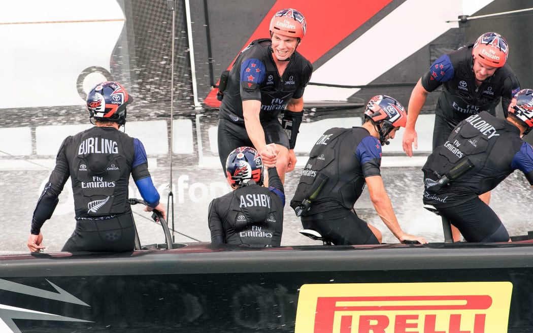 Team New Zealand sailors congratulate one another after beating Artemis Racing  in the third race of the America's Cup Challenger playoff finals.