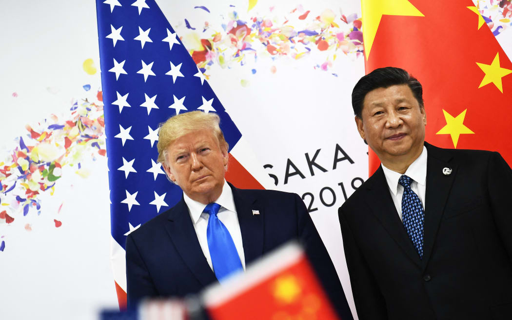 (FILES) Chinese President Xi Jinping (R) and US President Donald Trump attend their bilateral meeting on the sidelines of the G20 Summit in Osaka on June 29, 2019. Donald Trump will hold talks with China's Xi Jinping during the upcoming APEC summit in South Korea, the US president said in a Fox interview excerpt released October 17, 2025. (Photo by Brendan Smialowski / AFP)