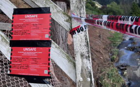 A red sticker at the boundary of a Dunedin property on 7 October after massive downpours caused floods, landslides and road closures.