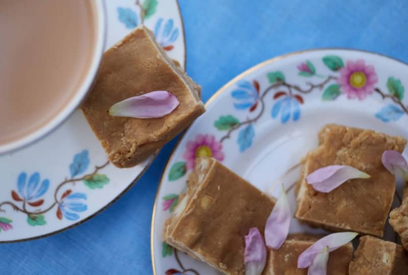 A plate of square slices of brown toffee.